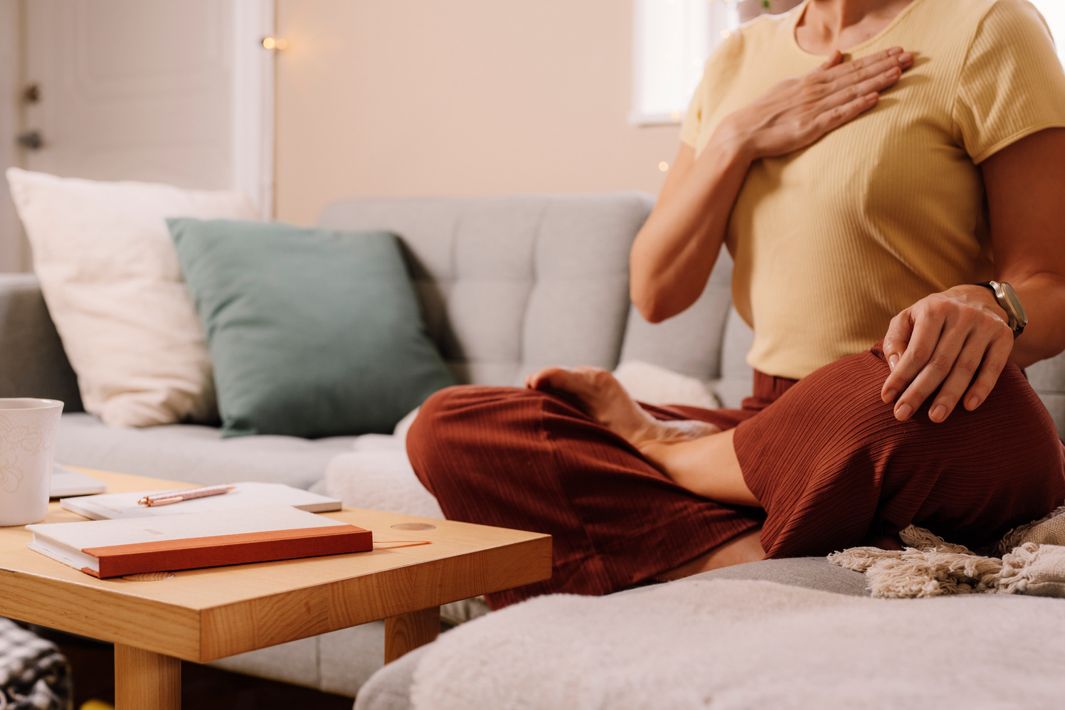 Woman indoors relaxing meditating and doing breathing exercises